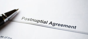 post-nuptual agreement document with pen sitting on top